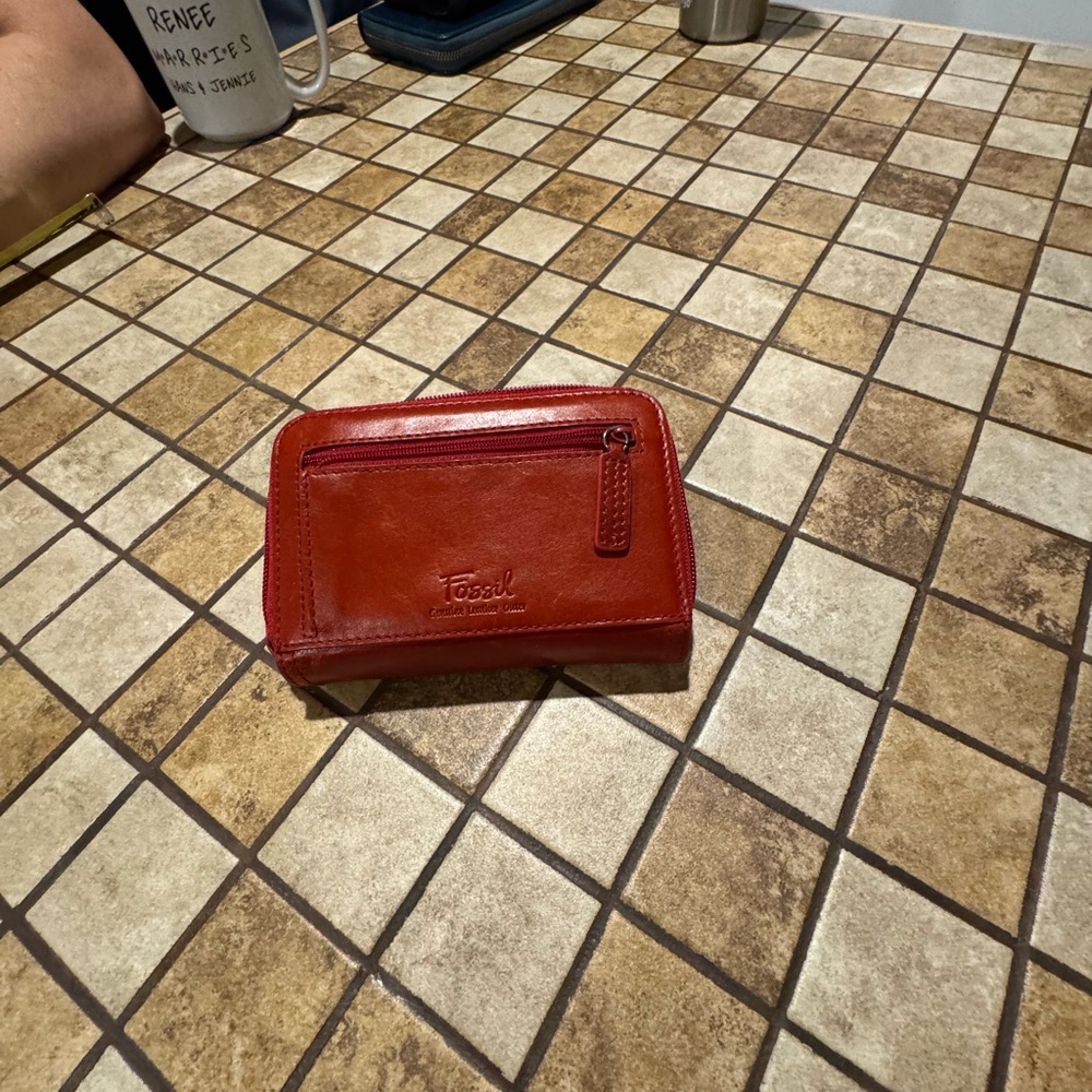 The item is a red Fossil brand wallet made